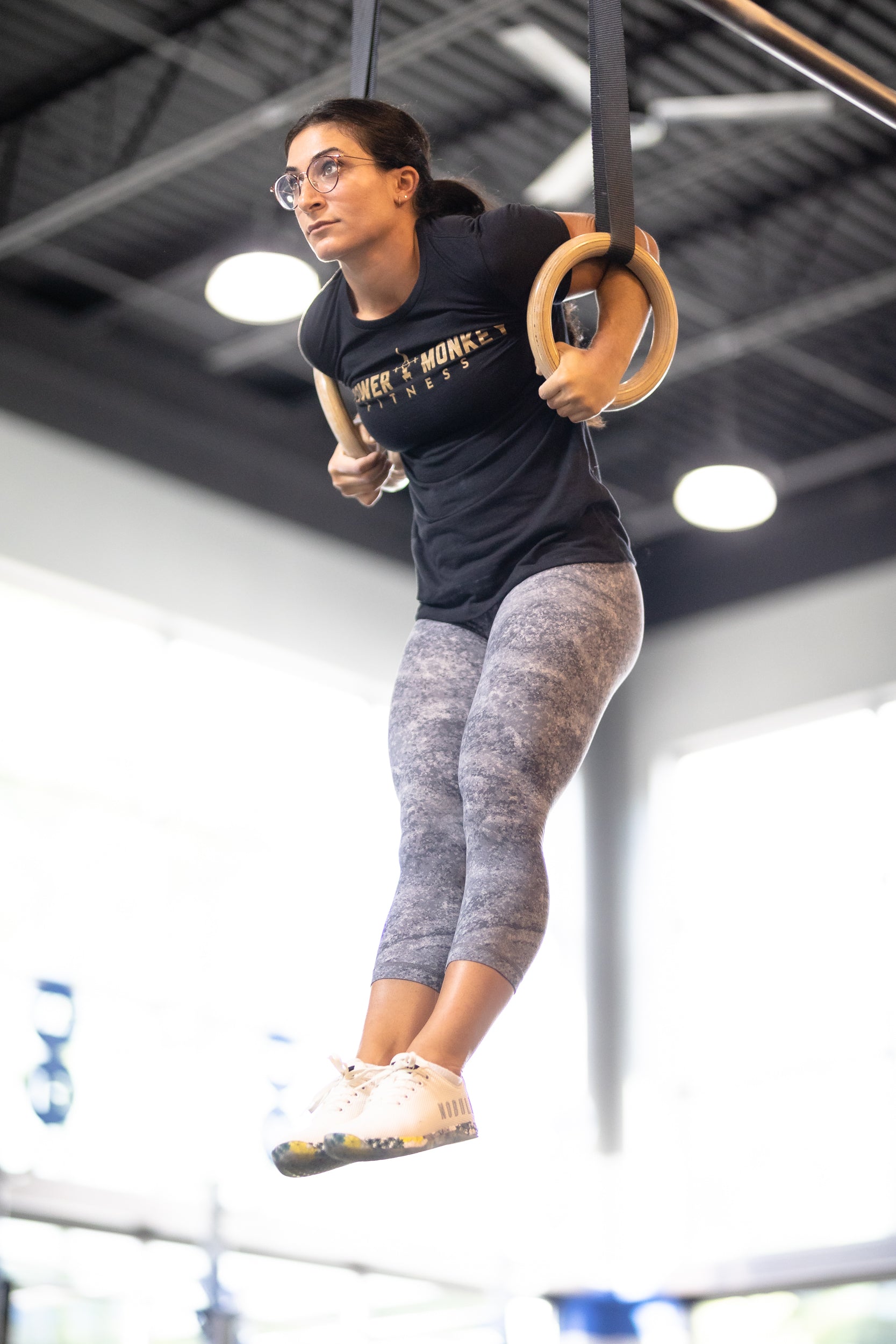 Image of a woman performing a kipping ring muscle up using the power monkey training app