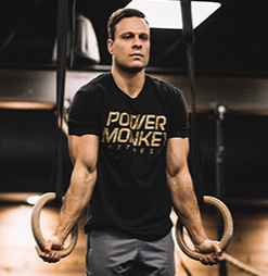 photo of Dave durante performing a ring muscle up in a gym.