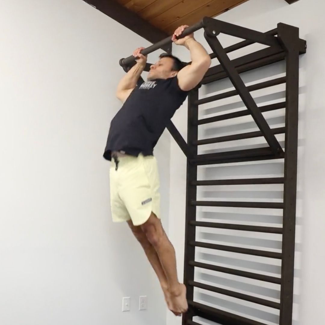 Image of a man performing a butterfly pull-up to promote the get your butterfly pull-ups in the Power Monkey Training app.