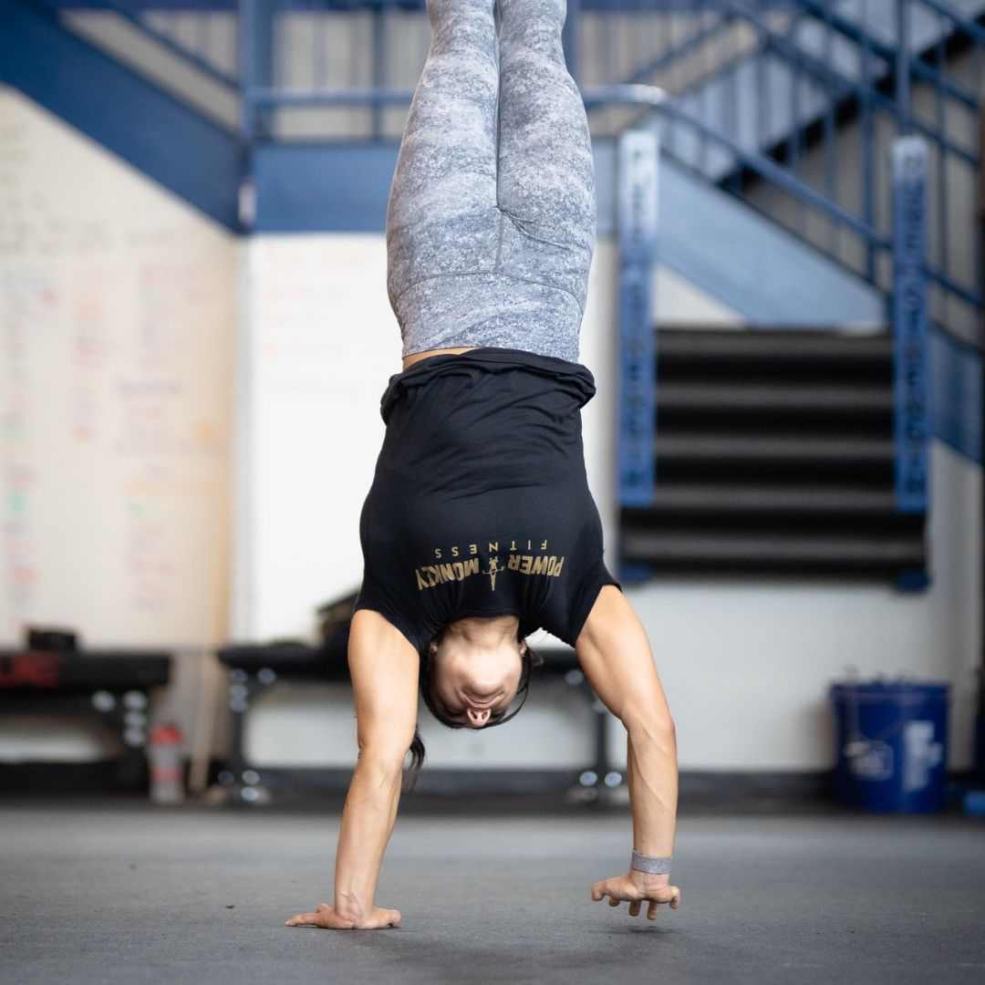Image of a woman performing a handstand walk to promote the handstand walking program in the Power Monkey Training app. 