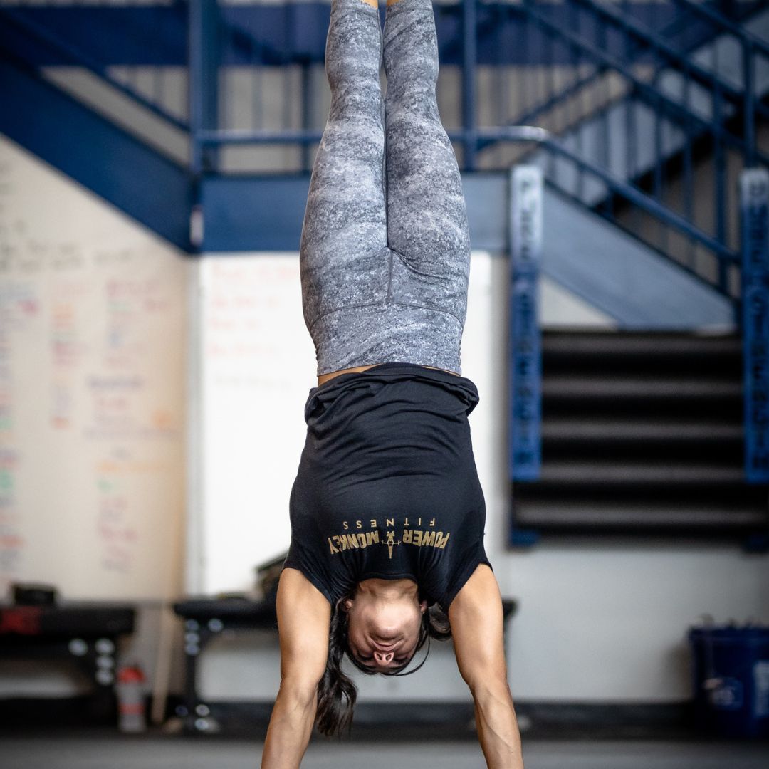 Image of a woman performing a handstand to promote the handstand program in the Power Monkey Training app. 