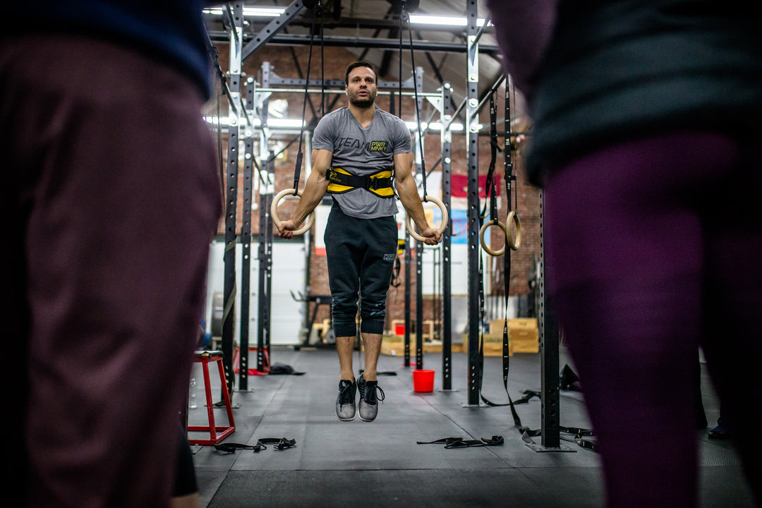 Gymnast Dave Durante demonstrating The Ring Thing in a CrossFit gym during a Power Monkey Fitness Course