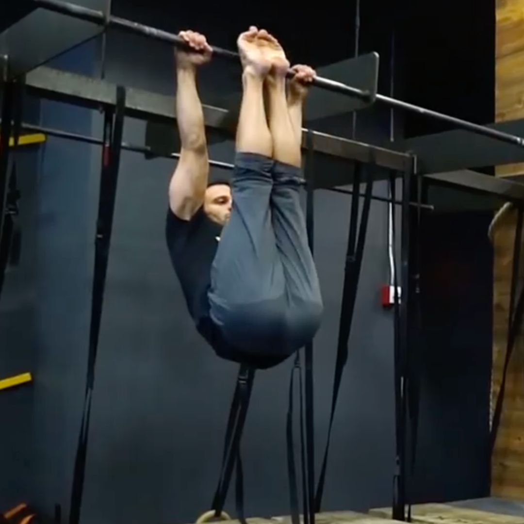 Image of a man performing a strict toes to bar to promote the strict toes to bar program in the Power Monkey Training app. 